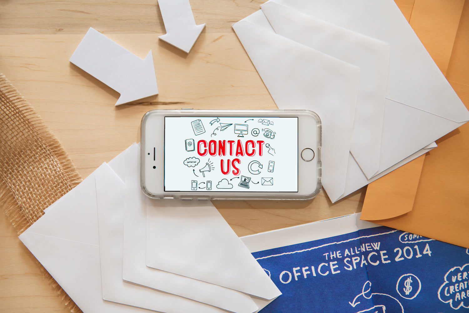 "Contact Us" being displayed on an iPhone in landscape view. It is sitting on a desk.